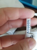 Closeup of elastic A zoomed in shot of blue zigzag stitching on white elastic, held by a pale-skinned hand