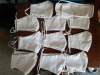 All the masks Eleven white Olson masks laid out on a brown background